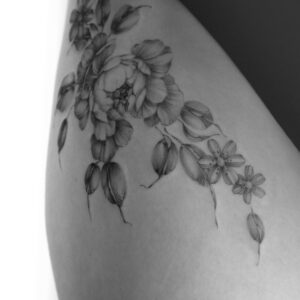 Fine line floral tattoo of hips, with peonies and leaves, tattooed at Vadelma Tattoo studio in Amsterdam